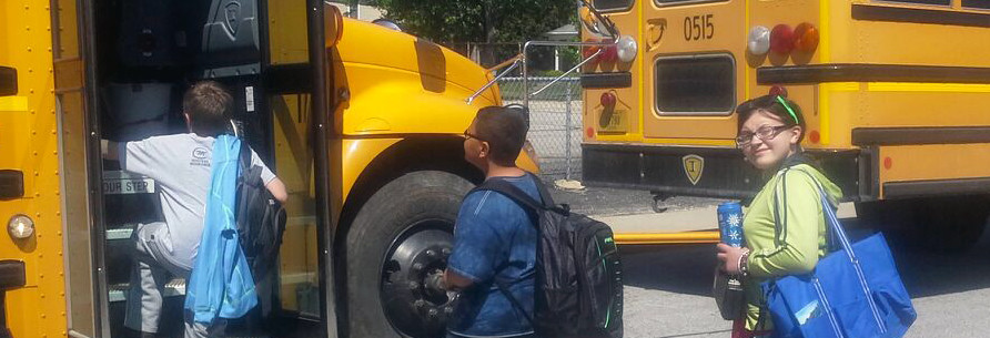 Students board a school bus